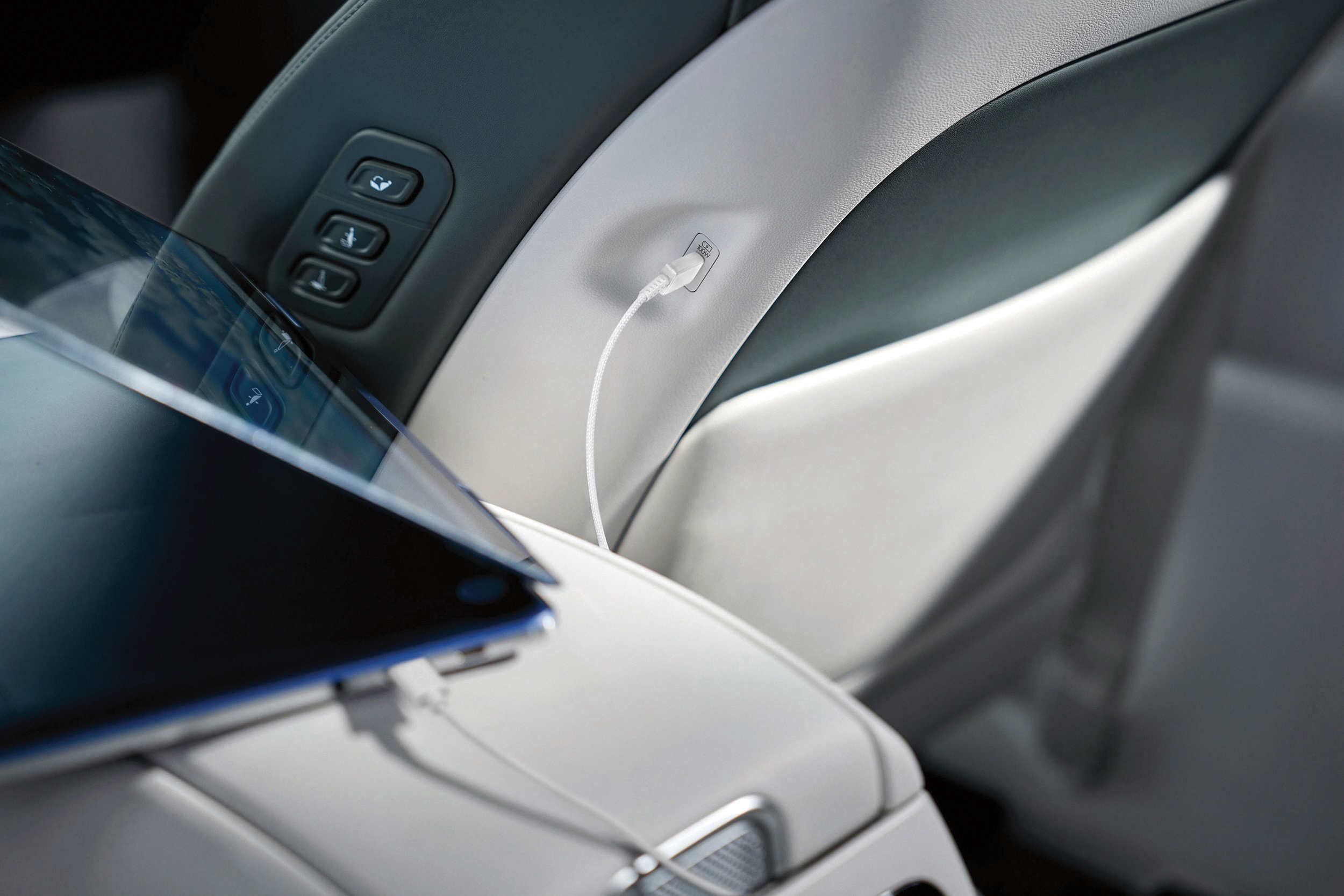 A Hyundai 100W USB-C cable charging a tablet computer in the IONIQ 9.